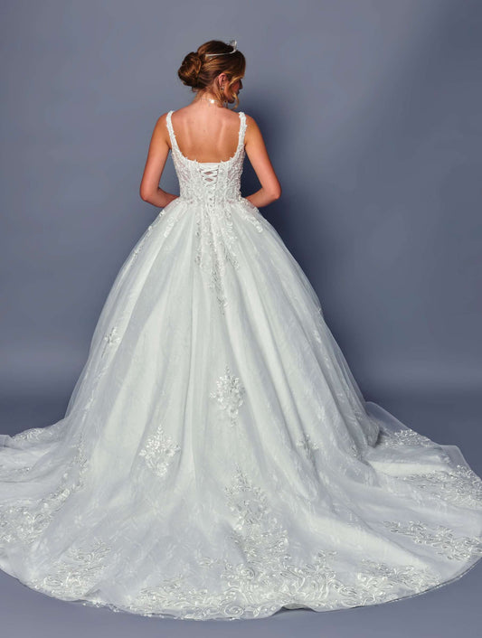 White wedding dress with intricate detailing on a plain background