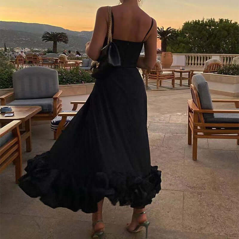 Elegant black swing skirt with ruffle hem, worn outdoors in a scenic setting during sunset.