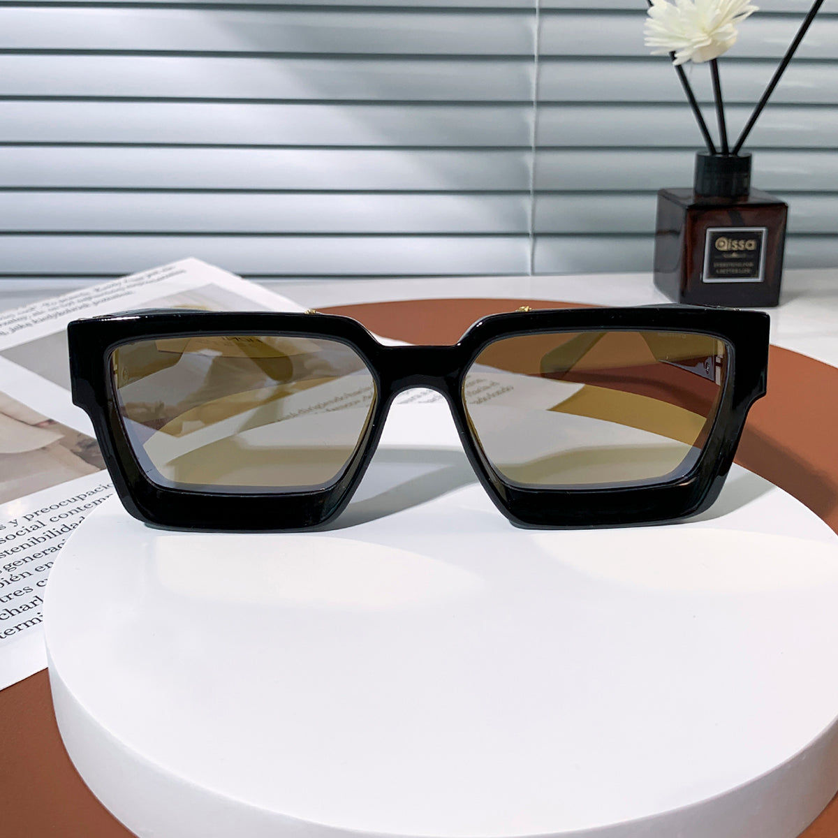 Black luxury sunglasses with gold accents on model