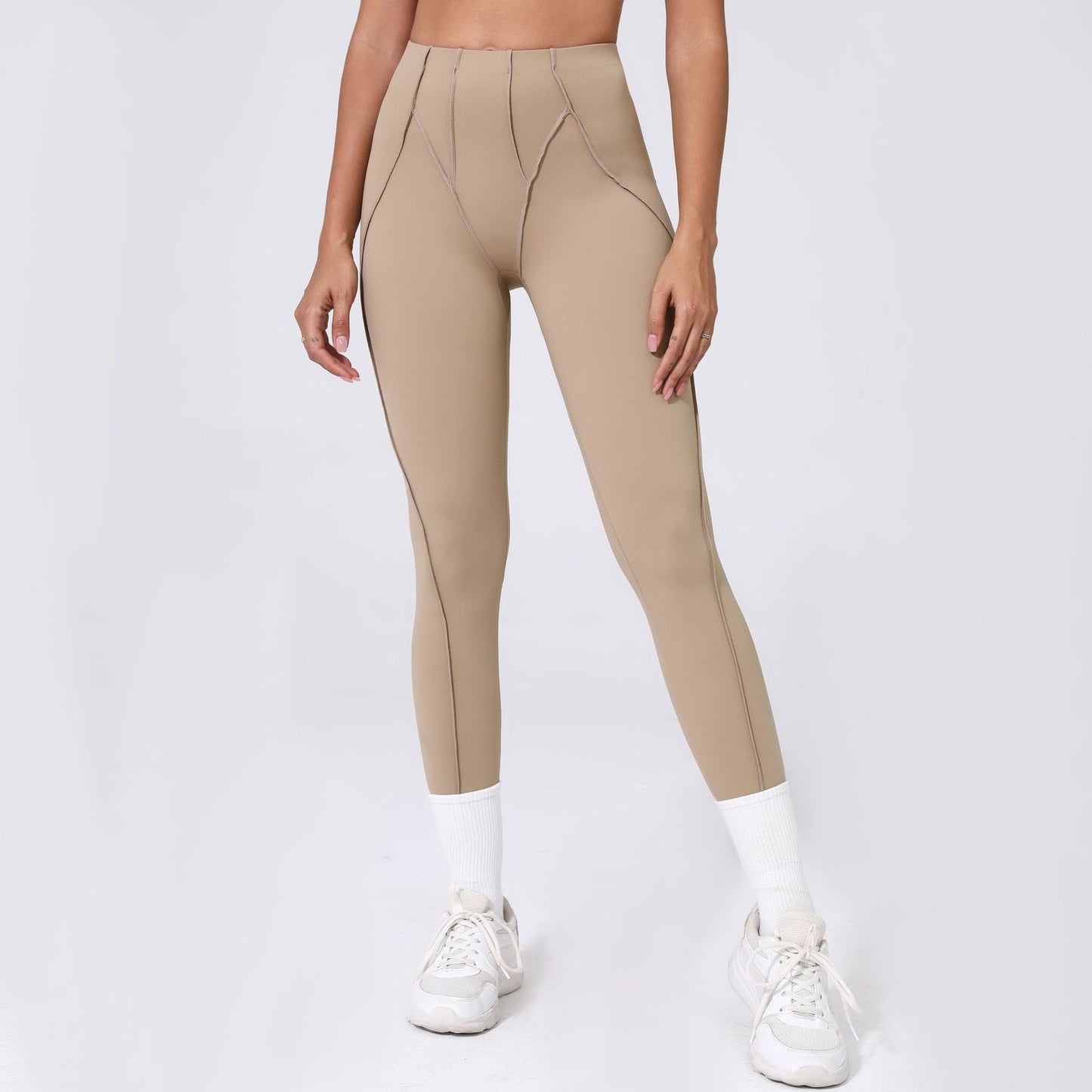 Beige leggings worn by a person on a white background