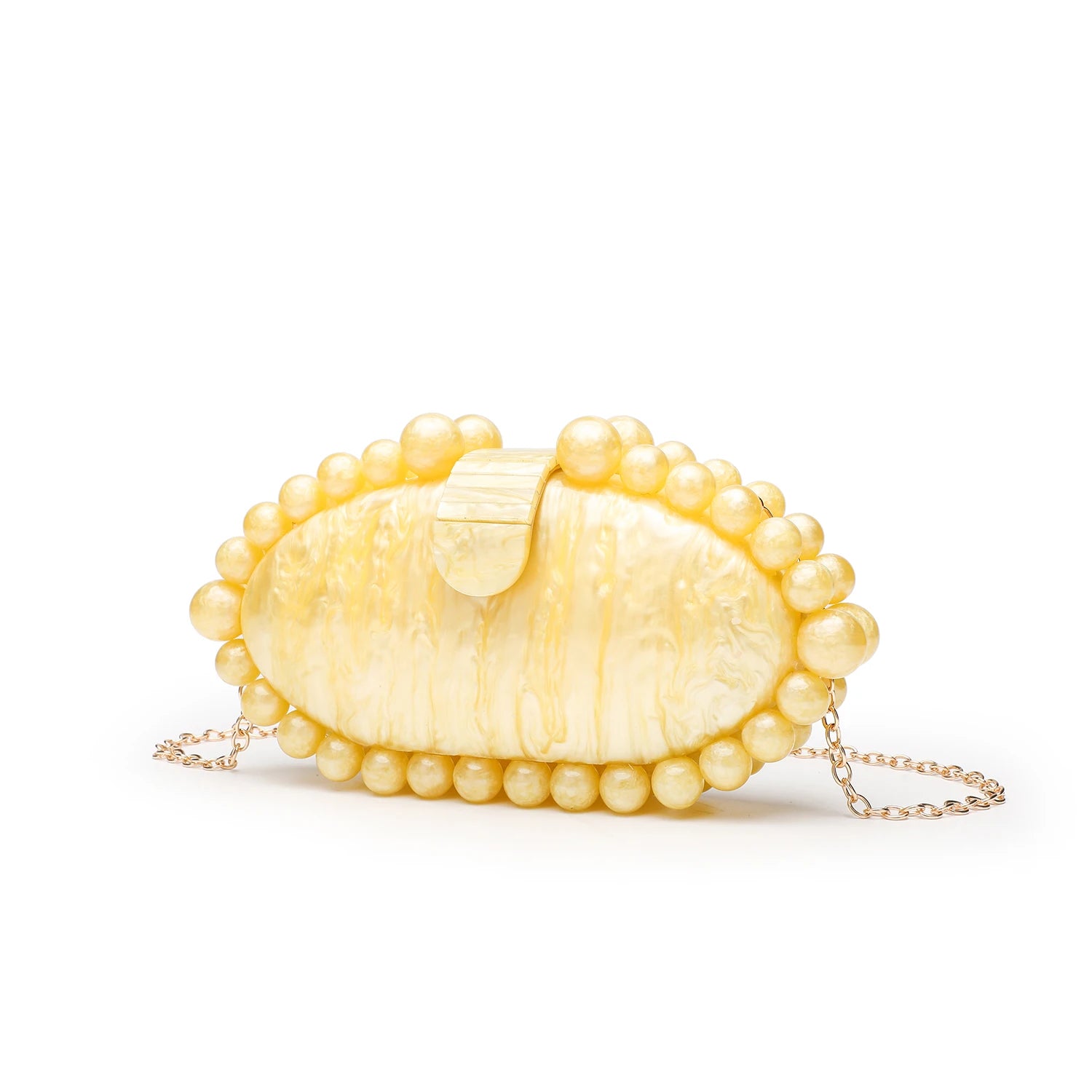 Yellow shell-shaped handbag with pearl-like beads.