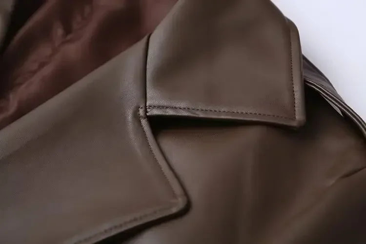 Close-up of a brown leather jacket with a focus on the collar.
