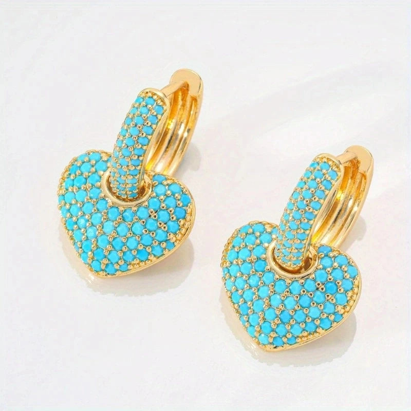 Gold hoop earrings with turquoise stones.