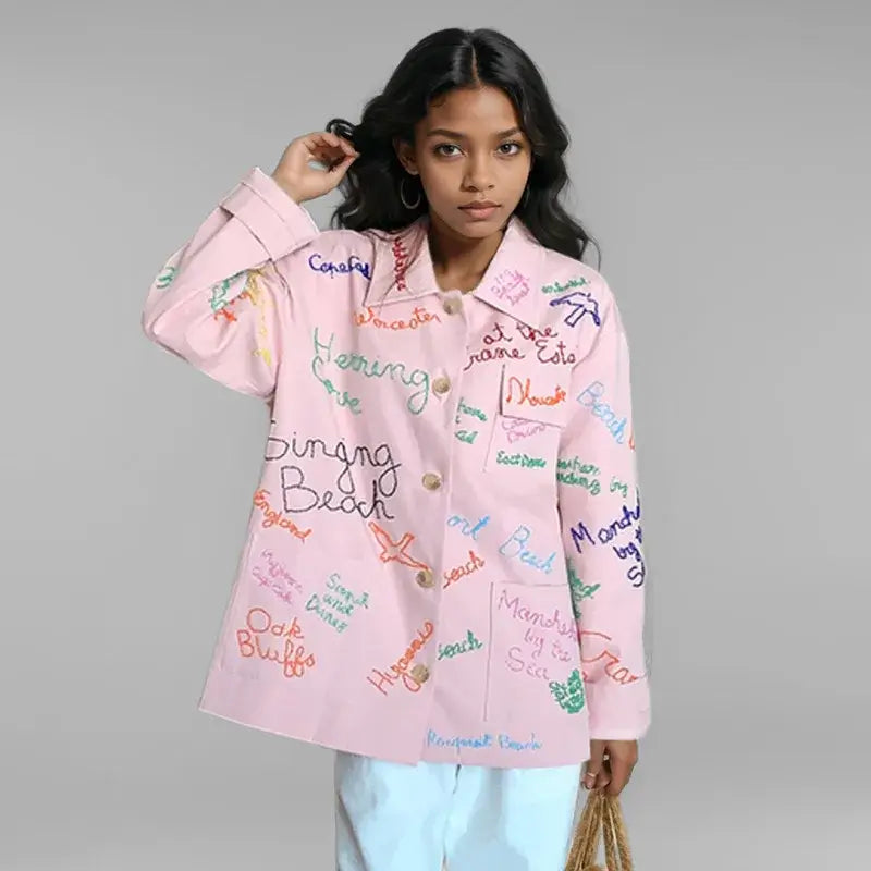 Trendy women's pink denim jacket with colorful letter design and turn-down collar, perfect for spring outings.