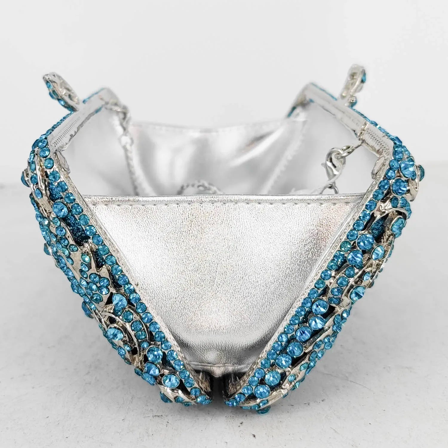 Silver handbag with blue gemstone.
