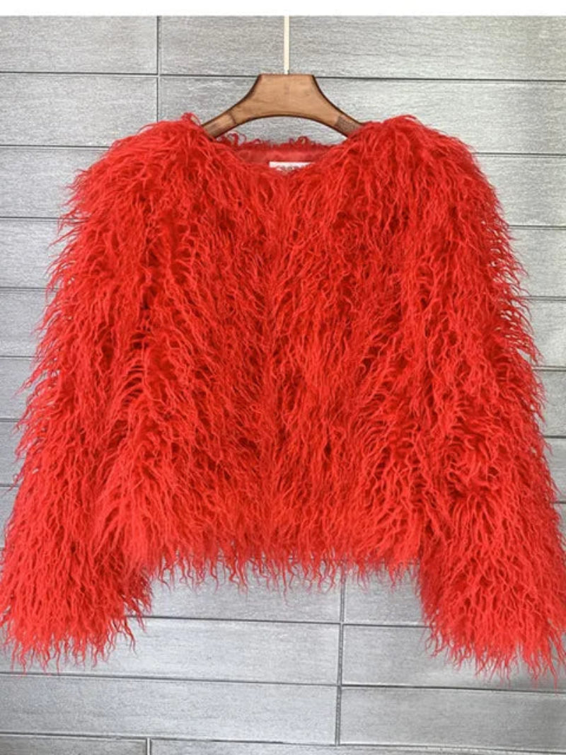 Red fluffy sweater on a wooden hanger 
