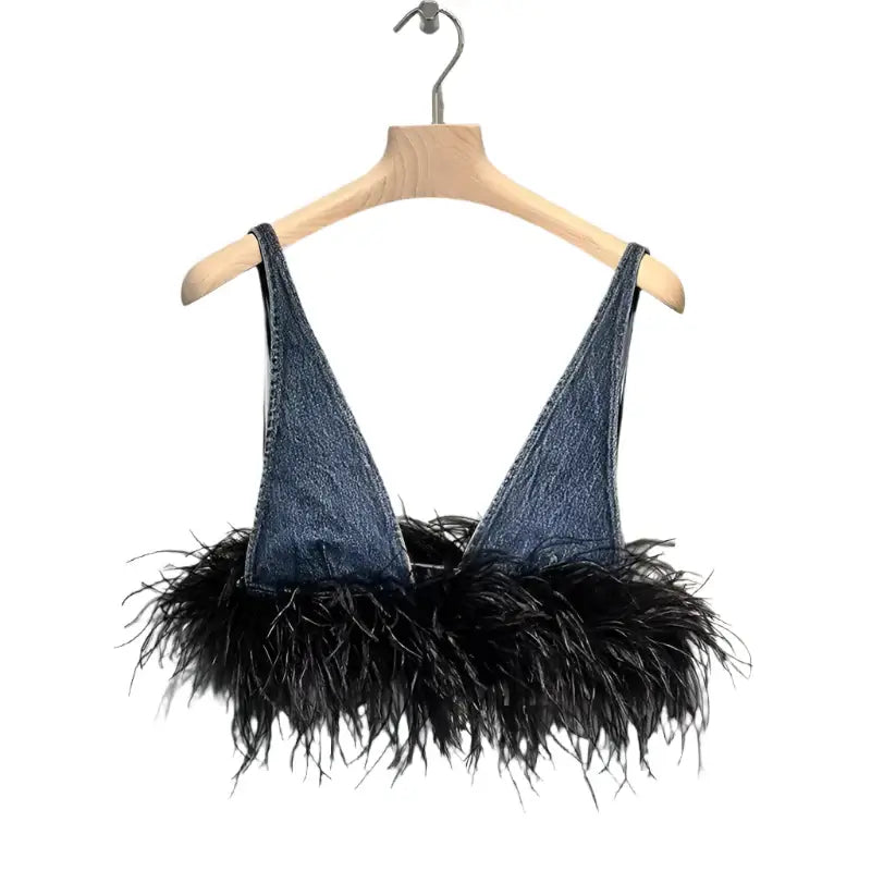 Trendy denim bralette with black feather detail on the hem, perfect for stylish layering or bold fashion statements.