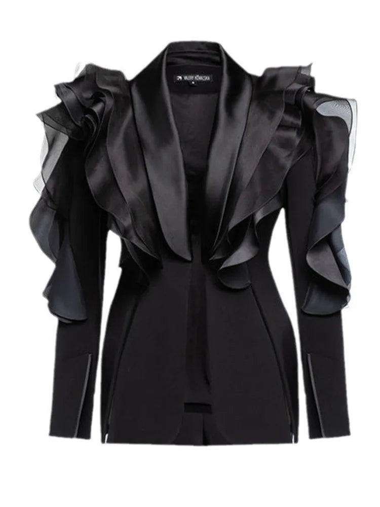 Black blazer with ruffled sleeves.