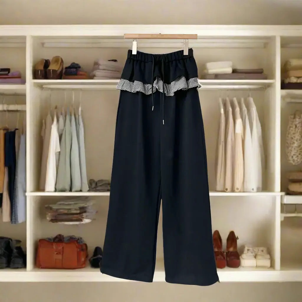 Women's Patchwork Plaid Pants displayed in a stylish wardrobe setup, showcasing unique plaid design and elastic waistband.