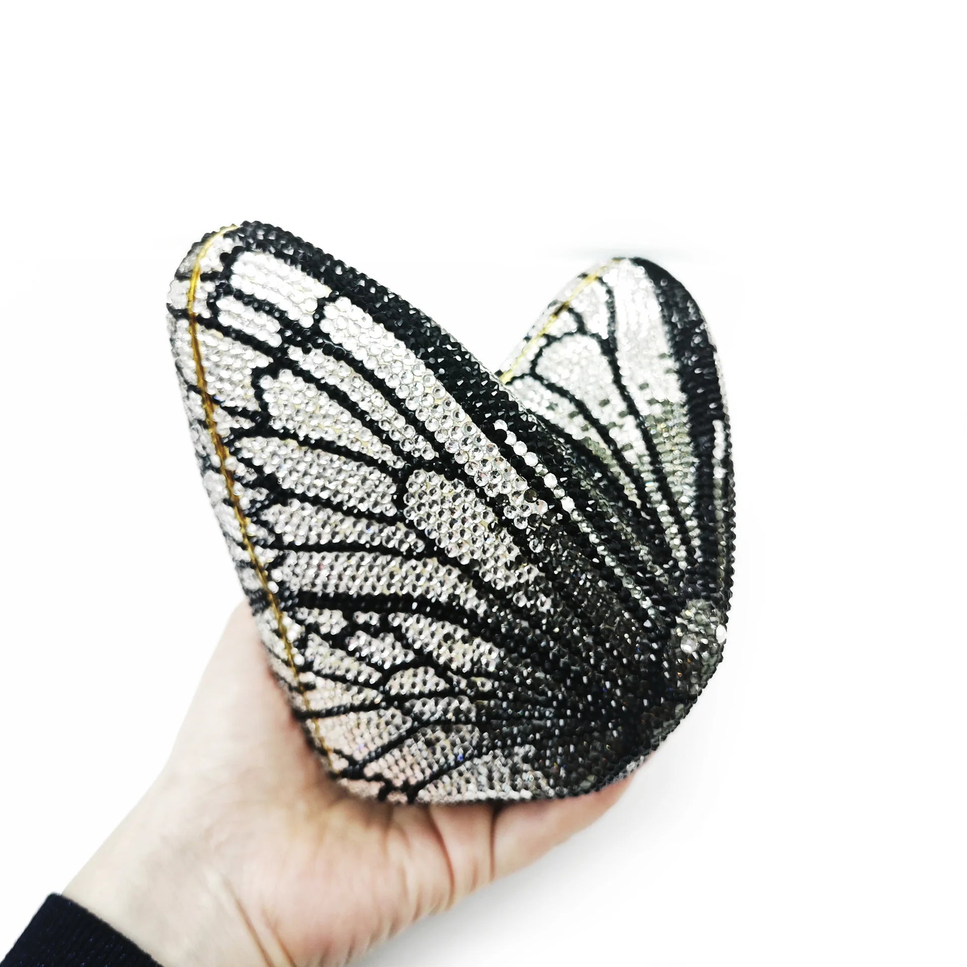 Butterfly-shaped clutch bag with black and white pattern.