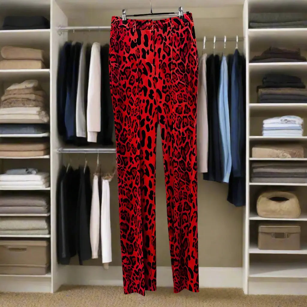 Red leopard print high waist slim pants hanging in a stylish closet, perfect for standout fashion.