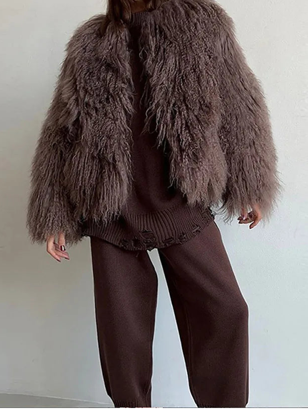 Person wearing a fluffy brown coat.