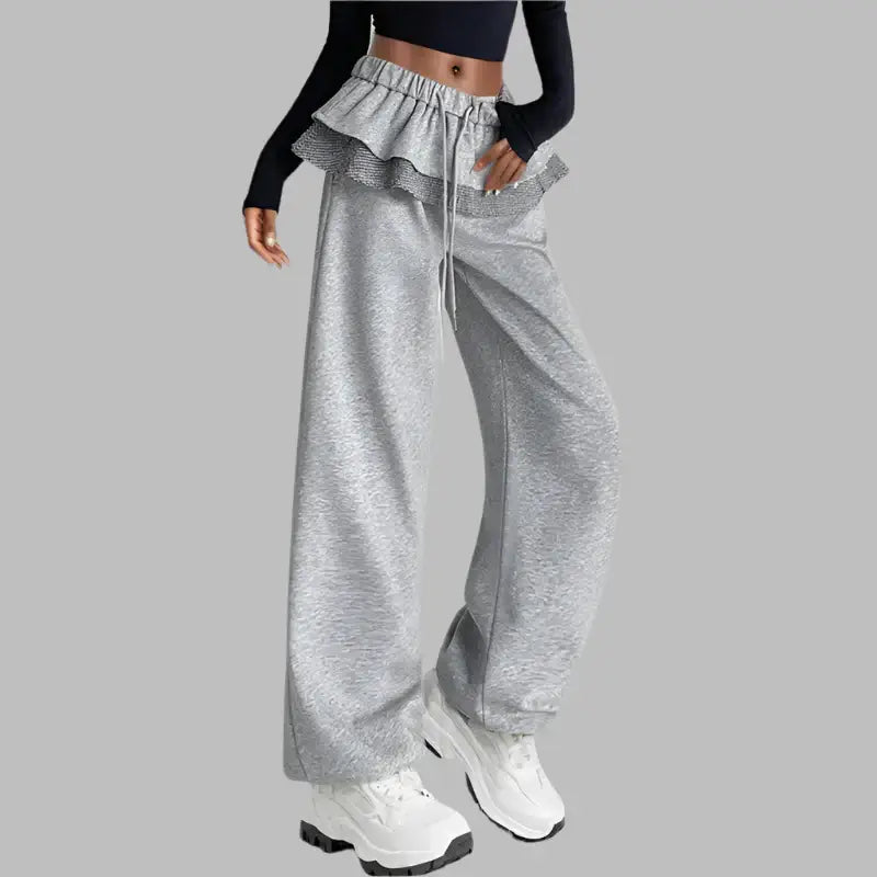 Stylish women's gray wide-leg pants with ruffle waistband, ideal for casual and trendy outfits.