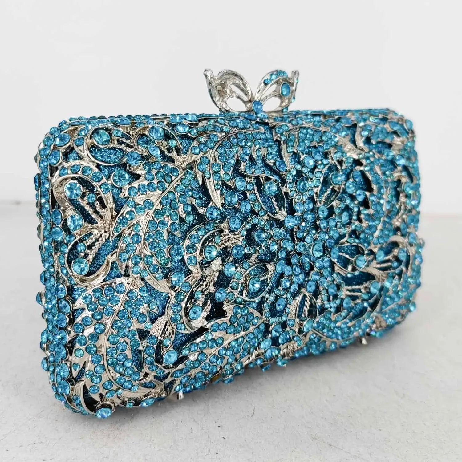 Blue and silver clutch bag with intricate design.