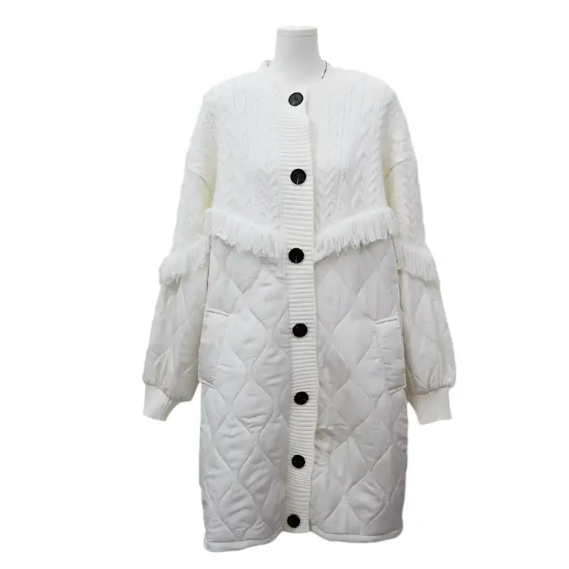 Women's white tassel knit long coat with button-up closure and quilted design, perfect for stylish warmth.