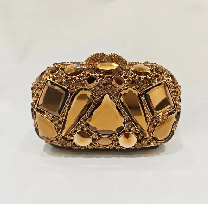 Gold clutch with gemstone embellishments.