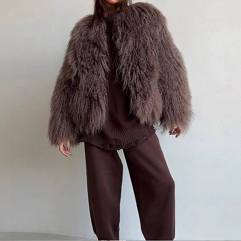 Person wearing a fluffy brown jacket.