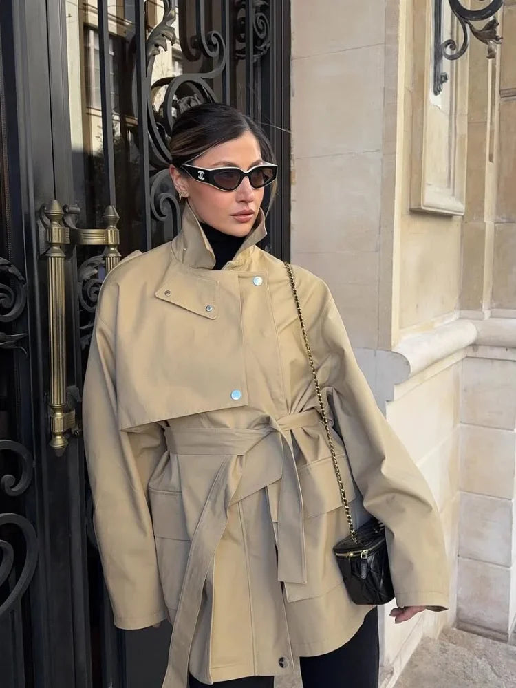 A woman wearing a beige trench coat 