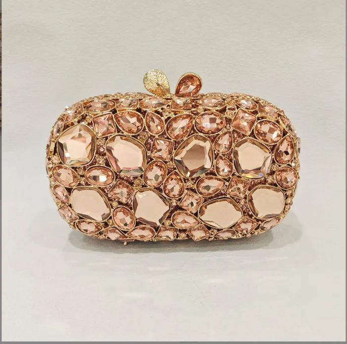 Rose gold clutch with gemstone embellishments.