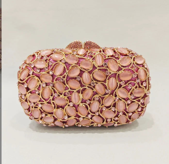Pink clutch bag with gold accents.