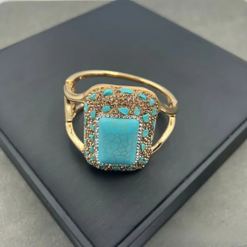Gold ring with a turquoise stone.