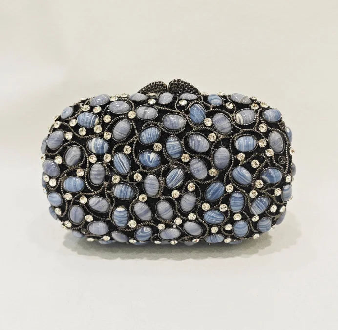 Elegant black clutch bag with blue stones.