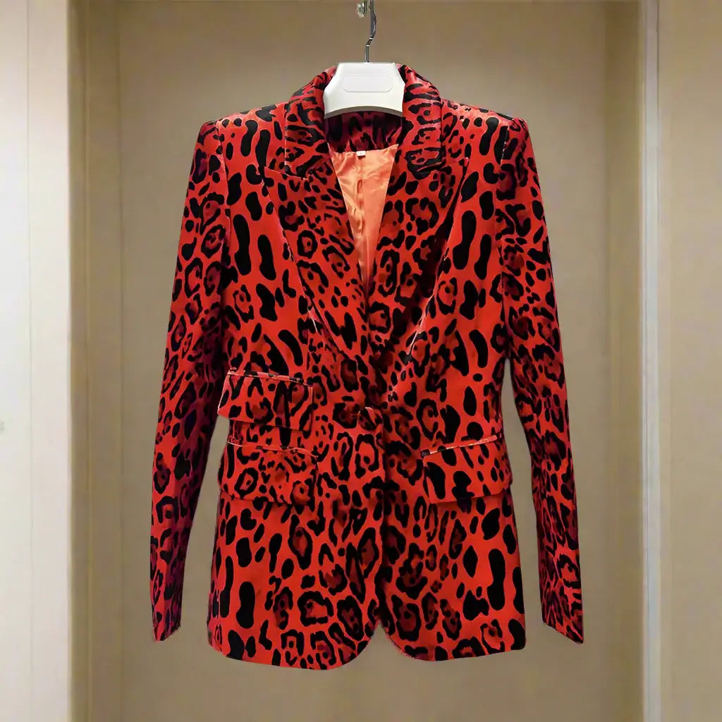 Women's leopard print velvet blazer on a hanger, featuring bold red and black patterns.