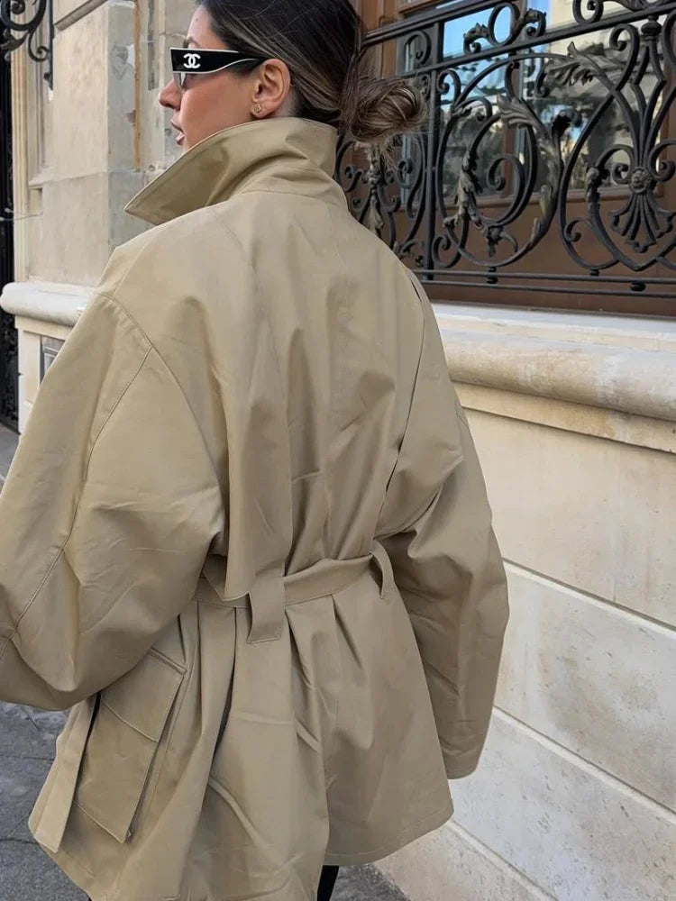 Person wearing a beige trench coat 