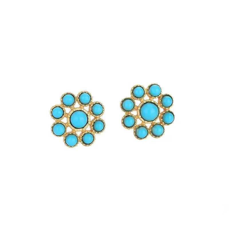 Pair of earrings with turquoise stones and gold accents.