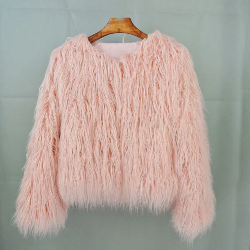 Pink fluffy sweater on a wooden hanger 