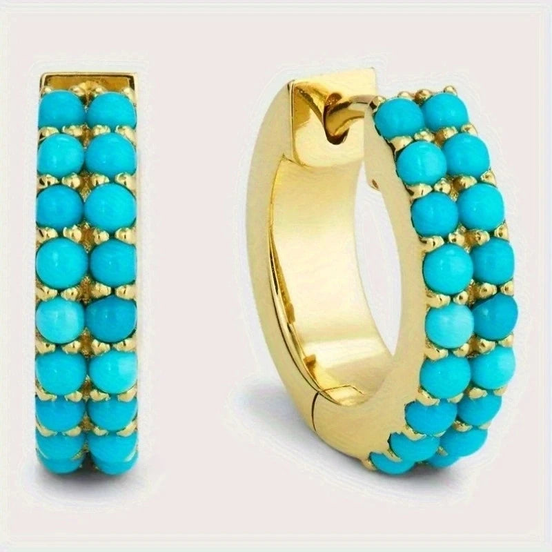 Gold hoop earring with turquoise beads.