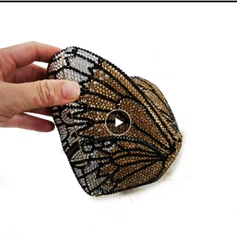 Hand holding a beaded clutch.