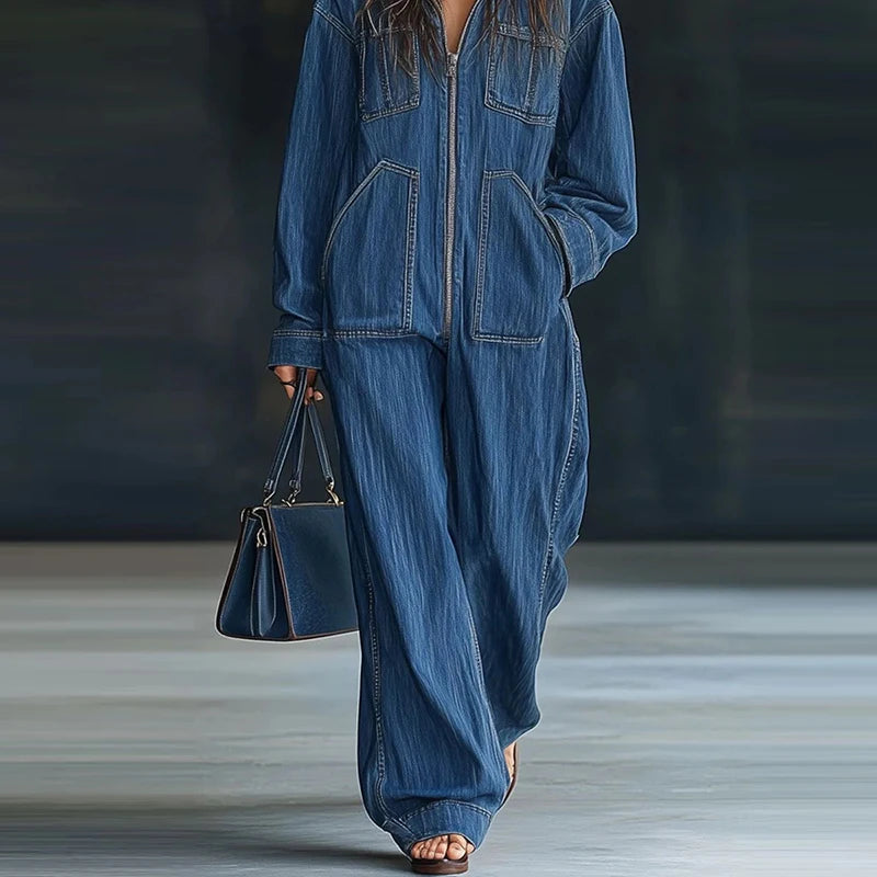Person wearing a blue denim outfit holding a matching handbag on a neutral background