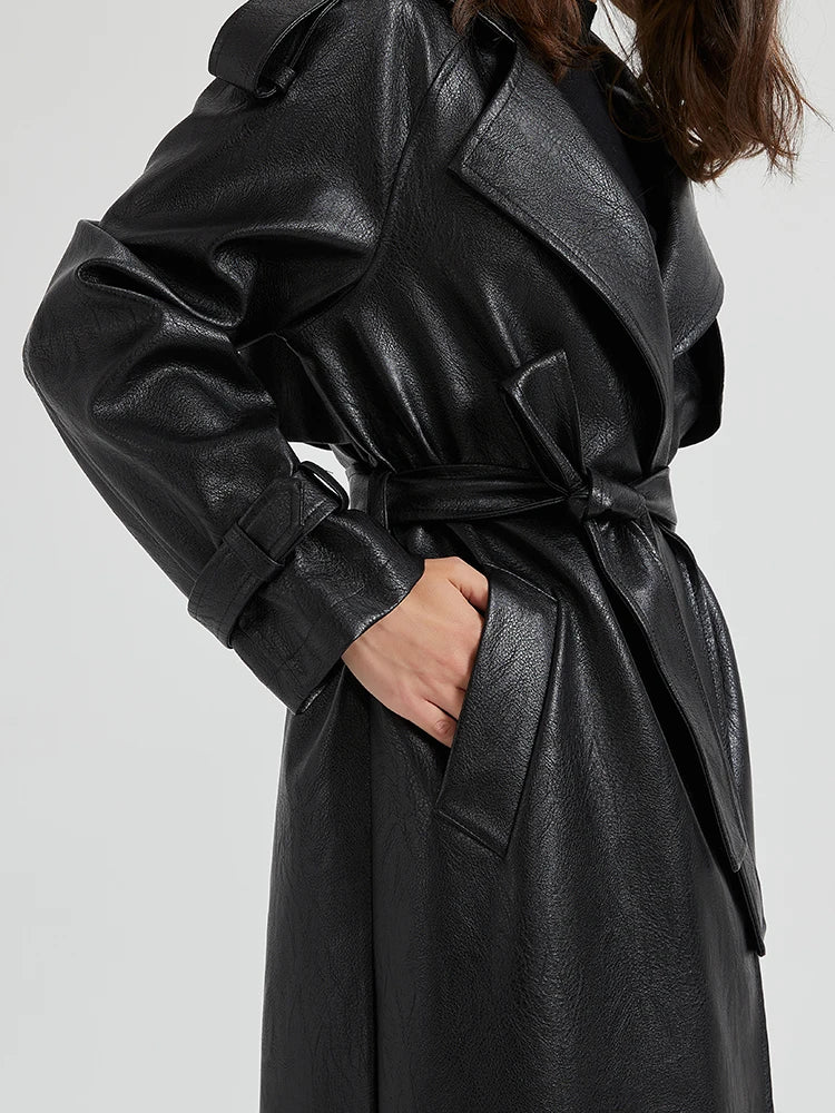 Black leather trench coat worn by a person.