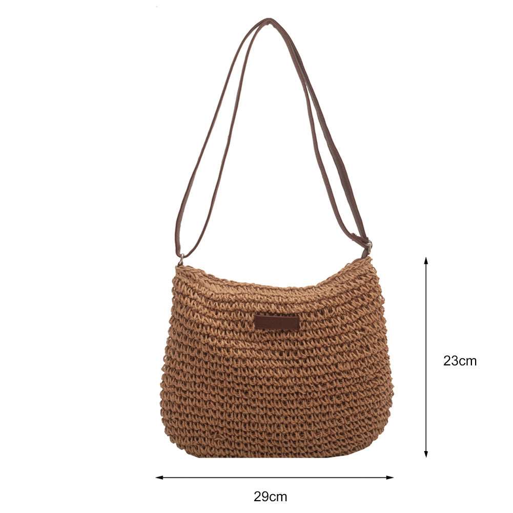 The HalleBeauty Vacation Straw Tote Bag, a tan woven shoulder bag crafted from straw, features a textured design with dual brown straps. Perfect for beach trips, it includes a small brand label and measures 29 cm wide by 23 cm high—your ideal stylish and spacious beach bag for travel.