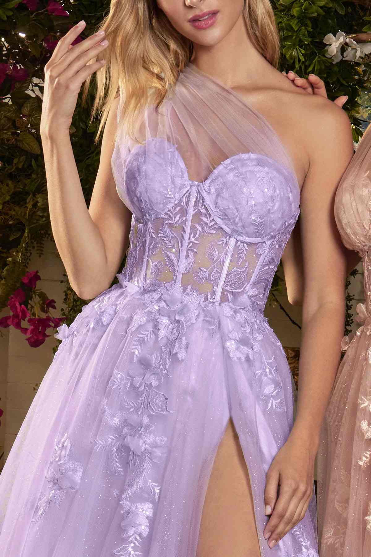 Woman wearing a lavender evening gown with floral lace details.