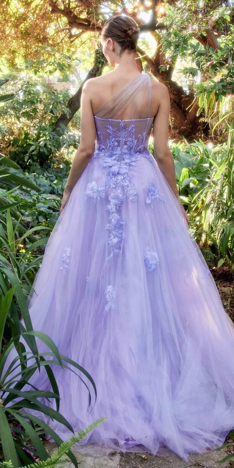 Woman in a lavender gown standing in a garden setting