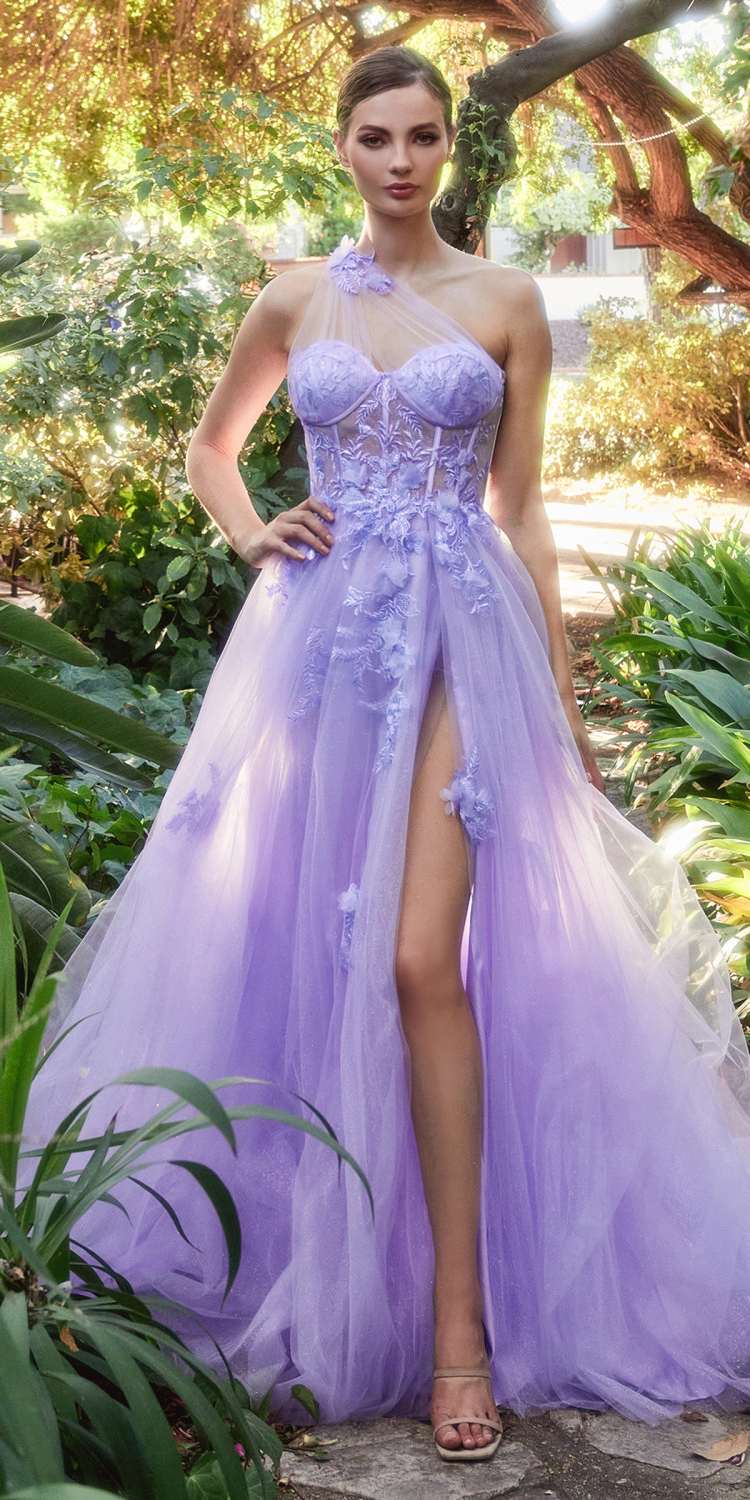 Woman in a purple gown standing in a garden