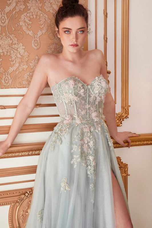 Woman in a light blue floral dress standing in an ornate room.