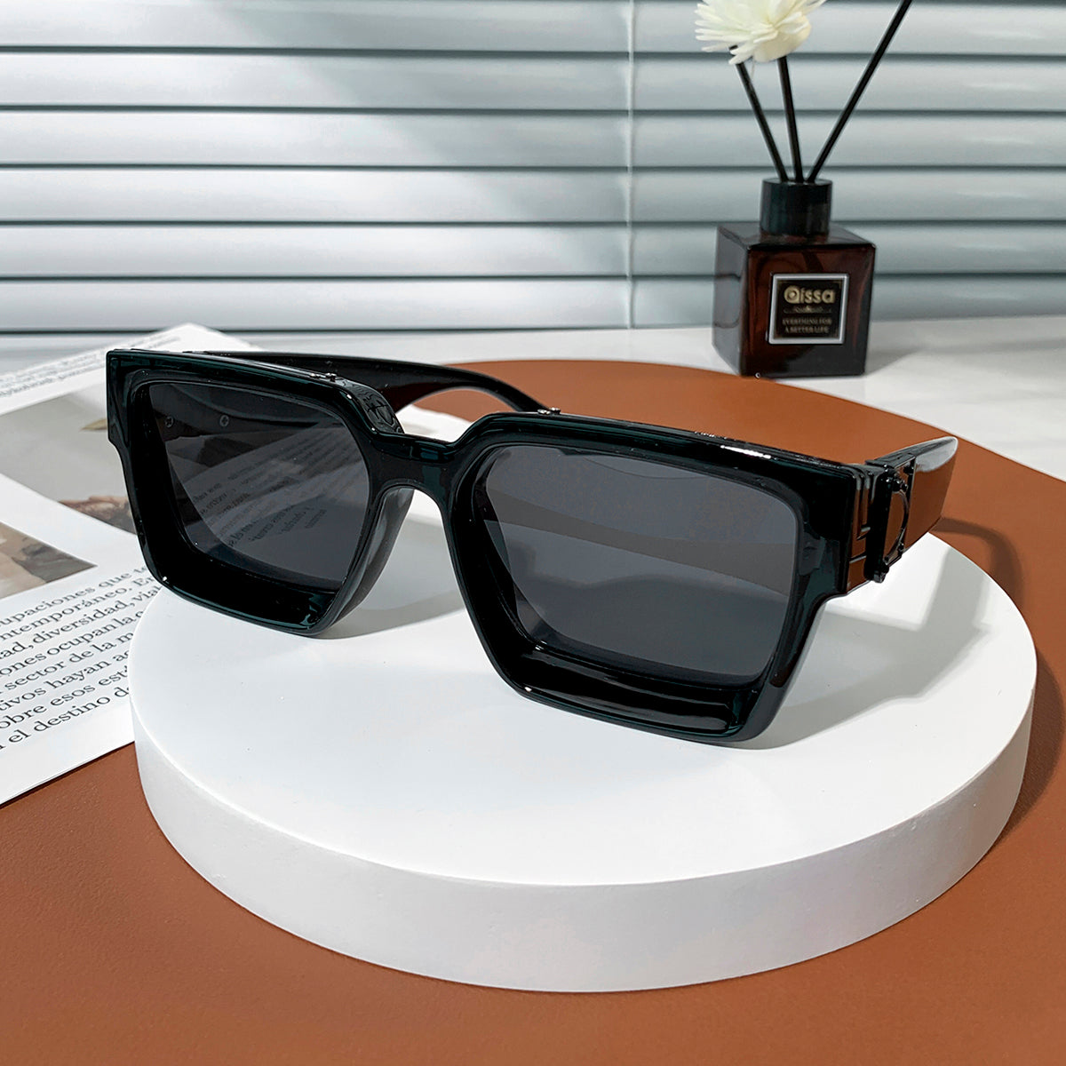 Black luxury sunglasses with gold accents on model