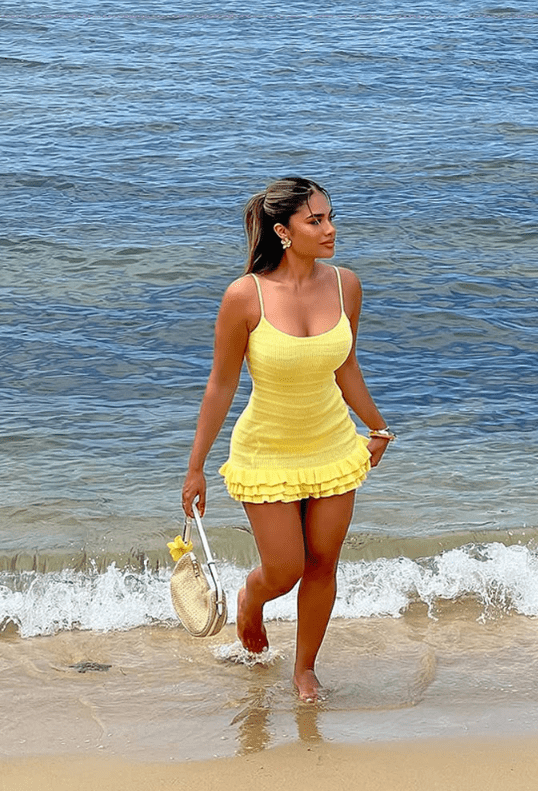 Women’s black knit maxi dress with metal buckle detail, evening gown style.- HalleBeauty