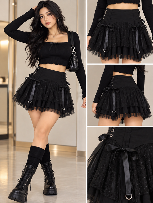 A model wears a black goth-style outfit featuring a long-sleeve crop top and a layered tulle mini skirt with black ribbons and metal eyelets. The image includes a full-body view on the left and three close-up detail panels on the right, all showing the outfit in an indoor setting.
